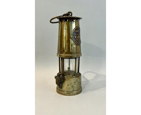 A vintage brass miner's safety lamp by The Protector Lamp and Lighting Co. Ltd., Eccles, Manchester, early 20th century, 26cm