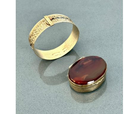 A 19th century gilt metal and agate snuff box - oval, 5cm long; together with a yellow metal adjustable bangle, early 20th ce