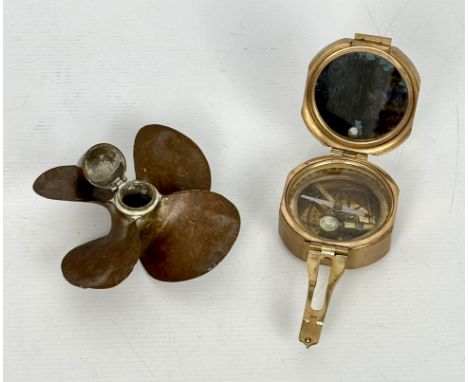 A novelty bronze propeller inkwell - first half 20th century, with hinged bomb-nose cover, 13.5cm diameter; together with a r