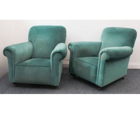 A pair of antique armchairs in the Howard style - 1920s-30s, upholstered in teal-blue velour, on later castors, 64cm wide, 83