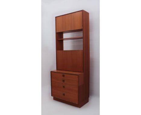 A G-Plan teak lounge unit - the top with a two-door cupboard over an open shelf and fall-front cupboard beneath, the base wit