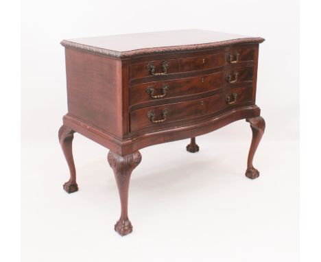 A&nbsp;mid-20th&nbsp;century Chippendale style oak serpentine chest of drawers - the&nbsp;carved, moulded top over three grad