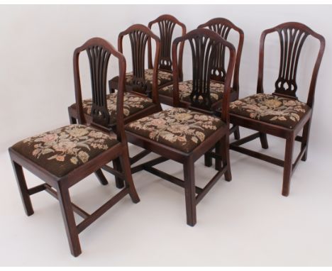 A set of six George III mahogany dining chairs - with pierced vase splats, drop-in seats upholstered in 19th century floral t