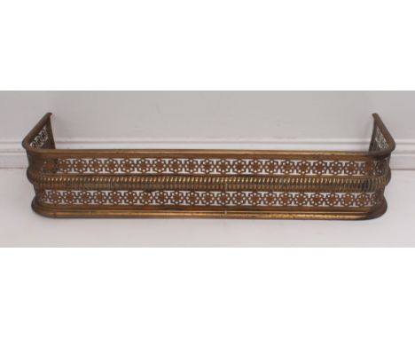 A Regency-style pierced brass fire curb or fender - probably Edwardian. (LWH 108 x 32 x 21cm)