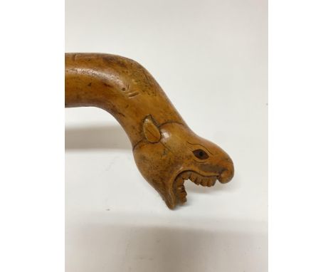 An antique Indonesian carved and inlaid rootwood walking stick in the form of a Tapir, 74cm.