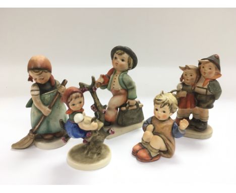 Five Hummel porcelain figures of children.