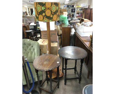 An Art Deco design standard lamp the lower section with small open shelves. and two oak occasional tables with a shaped edge.