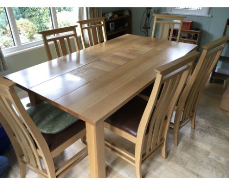 A modern light oak dining room suite with a set of six chairs with leather seats.(7)