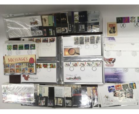 An album containing first day covers and a collection of presentation packs.