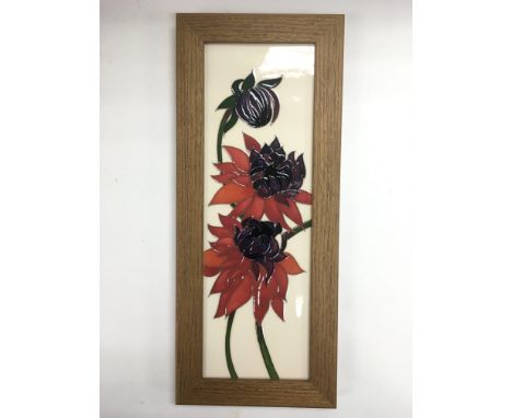 A framed Moorcroft tile, approx 14.5cm x 35cm including frame.