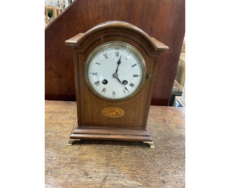 An inlaid Edwardian mantle clock together with an oak barometer.