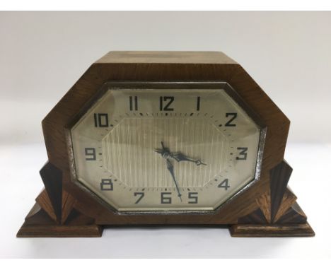 An Art Deco mantle clock with key, approx width 24cm.