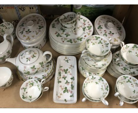 A Wedgwood dinner tea service decorated in the wild strawberry pattern. Including meat plates tureen plates cups and saucers.