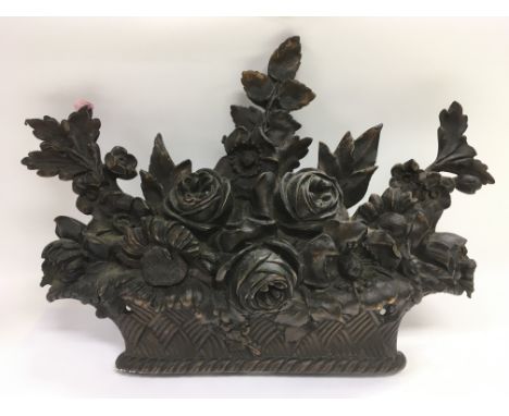 A bronze plaque in the form of a basket of flowers, approx width 51cm.