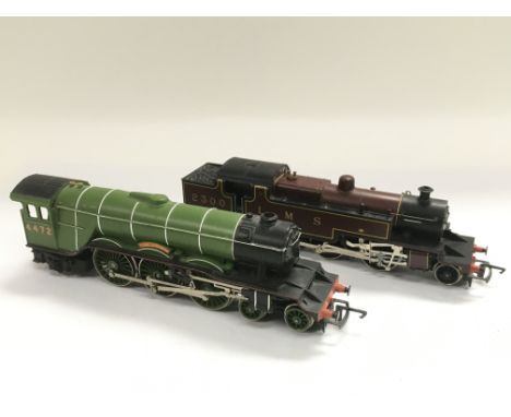 Two Hornby OO gauge model trains comprising The Flying Scotsman and one other.