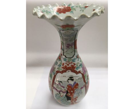 An early 20th Century Japanese vase with a frill top above a baluster body and decorated with painted panels of figures in a 