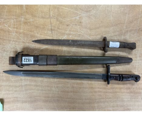 An American issue M1917 bayonet with scabbard together with a very worn bayonet