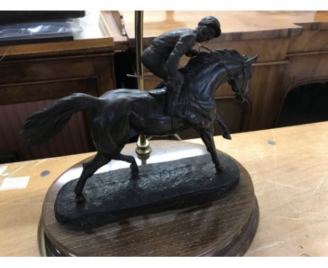 A side lamp surmounted with horse and jockey.