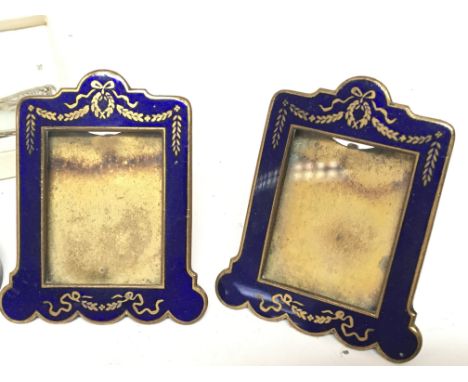 A pair of quality early 20th century blue enamel small photo frames a pair of fillagree sugar nips and an ebony and ivory mar