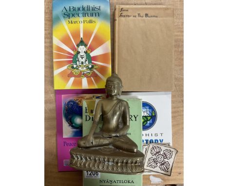 A collection of Buddhist related items to include reference books, a cast figure of Buddha, a Yellow hat gong, prayer wheel a