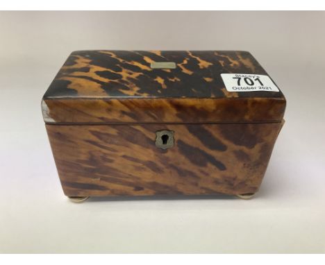 A small regency tortoishell veneered tea caddy with divided compartments complete with original lids.