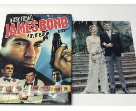 A signed photograph of Diana Rigg and George Lazenby together with The Official James Bind Movie Book (please note buyers mus