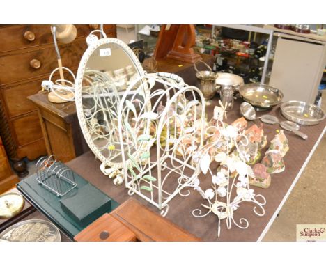 A metal wine rack; a floral metal light shade; and an easel oval mirror