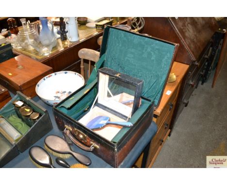 A vanity case lacking contents together with a trinket box with various labels and a silver and enamelled hand brush