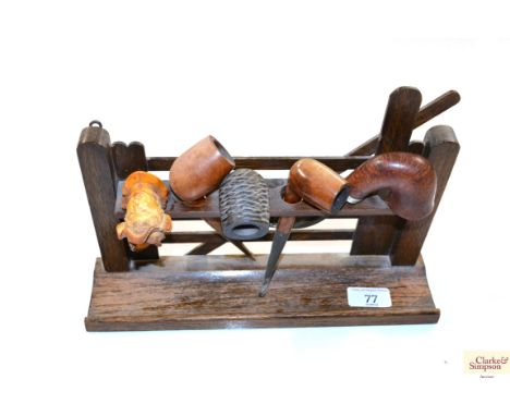 A pipe stand in the form of a gate and contents
