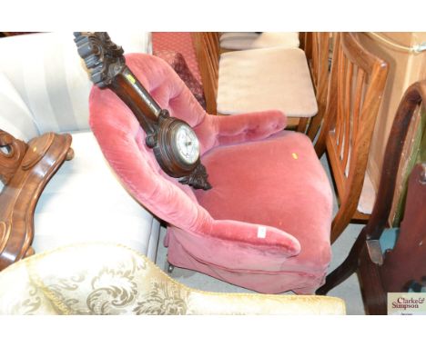 A pink upholstered button down nursing chair 