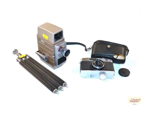 A Bell &amp; Howell Cine Camera, Ricoh 35mm camera and tripod