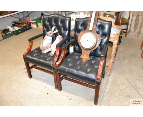 A pair of leather button down upholstered office chairs