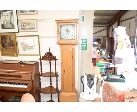 A antique stripped pine 30 hour longcase clock with pendulum and weights