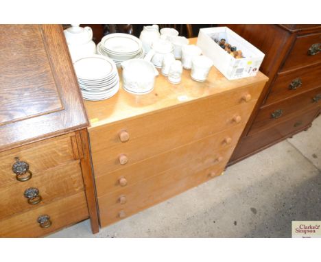 A vintage light wood chest fitted five long drawers 