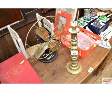 A vintage desk fan and a brass table lamp base 