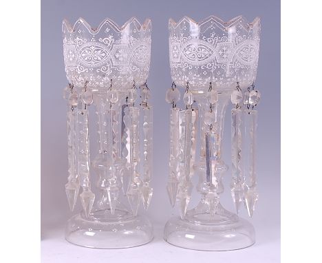 A pair of late Victorian clear glass lustres, each having gilded and white enamel bowls, faceted and cut glass drops, h.36cm