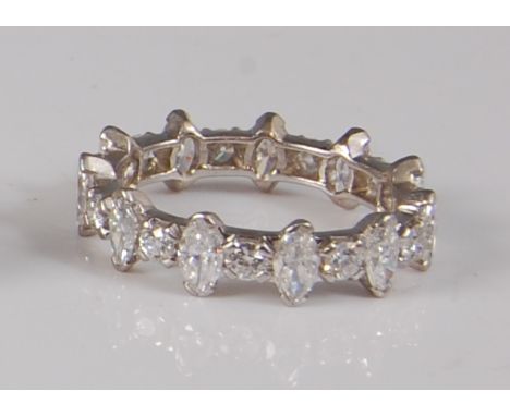 A continental 18ct white gold and diamond set eternity ring, arranged as alternating marquise and brilliant cut diamonds, tot