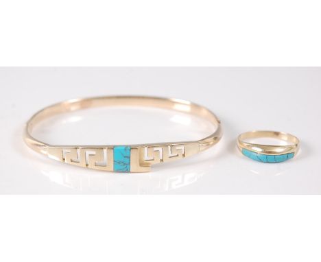 A yellow metal bangle and ring set, the oval hinged bangle featuring a Greek Key design to the front inlaid with a 7.5 x 5mm 