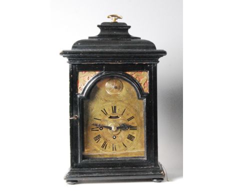 A late 18th century Dutch ebonised bracket clock, having engraved arched brass dial, with subsidiary convex repeat dial to th