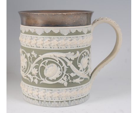 A Wedgwood green jasper ware tankard, having a silver rim hallmarked London 1903, the tankard decorated with bands of scroll 