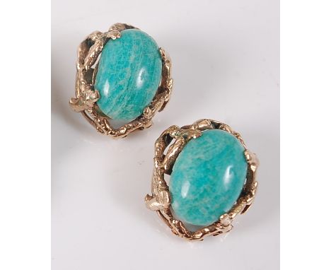 A pair of 9ct yellow gold abstract earrings, each featuring an oval dyed green cabochon stone within a textured openwork surr