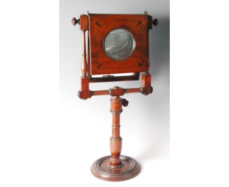 An early 19th century mahogany pedestal zograscope, the rectangular hinged mirrorplate and hinged magnifier on ring turned an