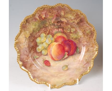 A Worcester porcelain cabinet plate, decorated with fruit on a mossy bank by R. Sebright, signed lower right, all within a gi