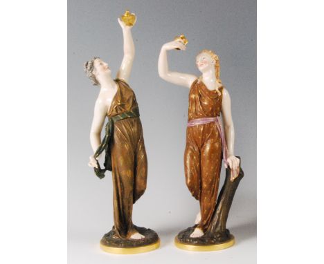 A pair of Royal Worcester porcelain figurines depicting Liberty and Captivity, each holding a dove, embellished in gilt, impr