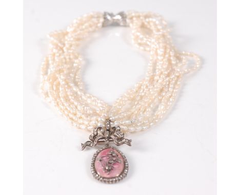 A ten row twisted baroque freshwater pearl necklet, with an oval pendant in pink guilloche with inner floral motif, set with 