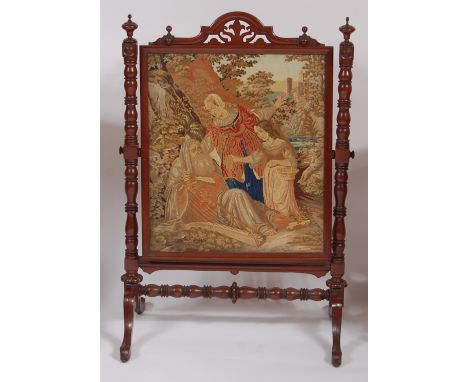 An early Victorian mahogany and tapestry embroidered fire screen, the embroidery depicting classical figural landscape scene,