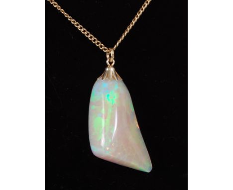 A polished opal pendant, weighing approx 25 carats and measuring approx 60 x 17 x 12mm, on finelink 14ct gold neck chain