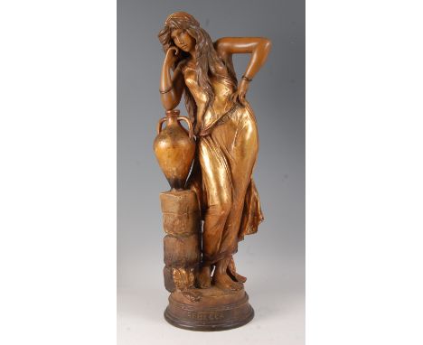 An early 20th century Goldscheider Art Nouveau terracotta figure of Rebecca, painted and gilt decoarated, modelled in standin