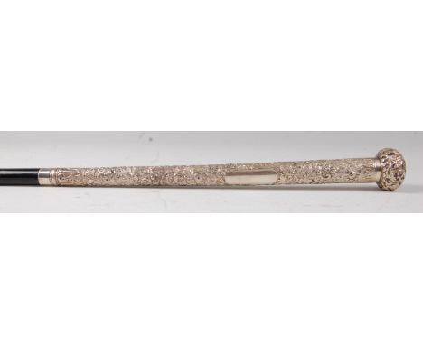 A late 19th century Indian silver and ebony parasol handle, of good weight, having vacant cartouche within a surround of embo