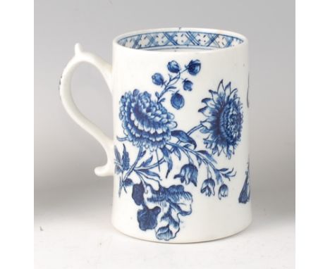 A Lowestoft porcelain mug, circa 1770, underglaze blue decorated with floral prints and butterflies, the interior with cell d